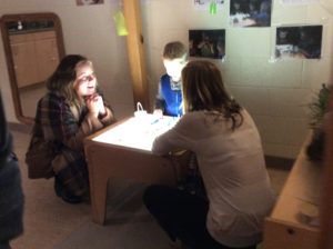 Light table with child and educators
